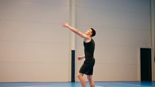 Male Volleyball Player Practicing Serve on Indoor Court