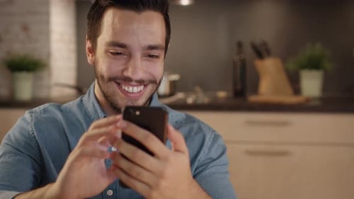 Man Using Smartphone in Kitchen Close Up