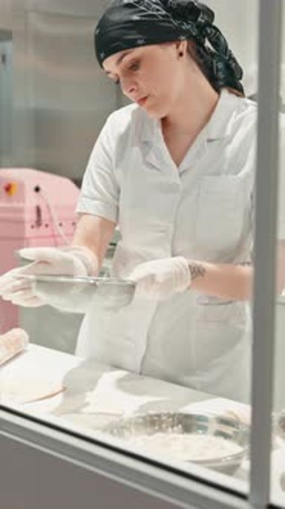 Woman, pastry chef or flour with sieve in bakery kitchen for bread ...