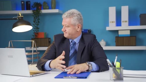 Worried Man Gesturing in Office Environment