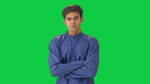 Angry Indian man judging and observing someone Green screen