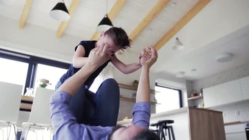 Smiling Girl Playing With Dad Inside Home
