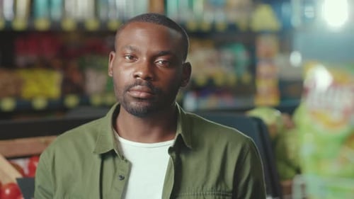 Portrait Serious African American Young Man Look at Camera in the Supermarket Business Ethnic Food