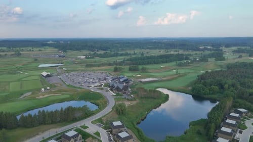 Modern golf course aerial orbit with bunkers and water features