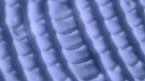 Cream Texture with a Pattern of Stripes and Furrows in Purple Color Face or Body Cosmetic Product