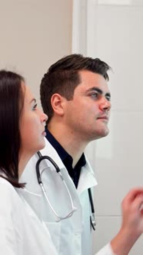 Dedicated Medical Team Analyzing Xray Images on a View Box