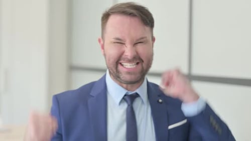 Celebrating Businessman Pumping Fists in Air