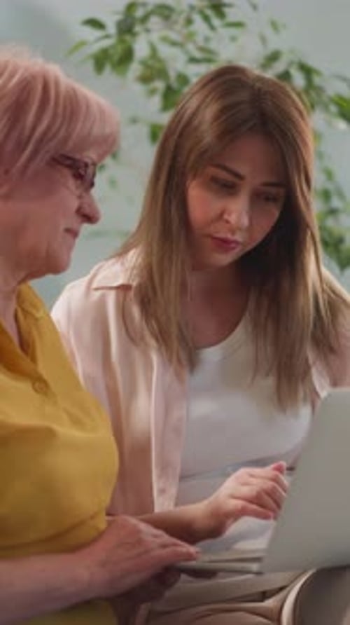 Daughter Shows Video on Laptop to Senior Mother at Home
