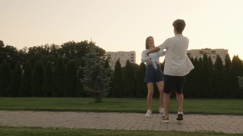 Couple In Love Spinning In The Park