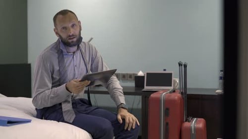 Young Businessman Explains Hotel Tablet