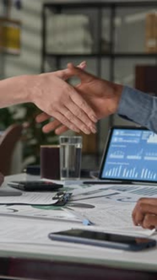 Business Handshake Meeting in Office with Tablet Display