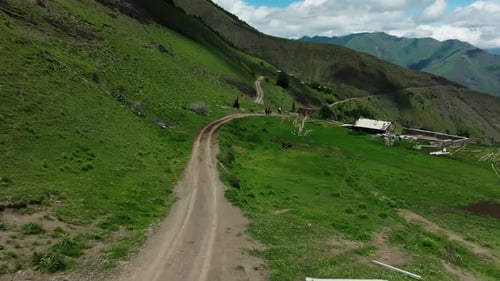 Winding Mountain Road in Green Countryside Aerial View of a Serpentine Road Snaking Through Lush