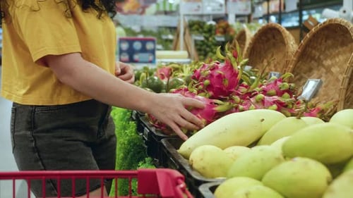 Pretty Young Woman Making Purchases in Supermarket Choosing Products at Supermarket for Cooking