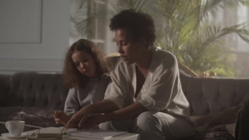 Woman and Child Reading a Book Together