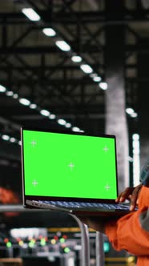 Vertical Video Chroma Key on Laptop Screen with Engineer in Helmet Examining Metalwork