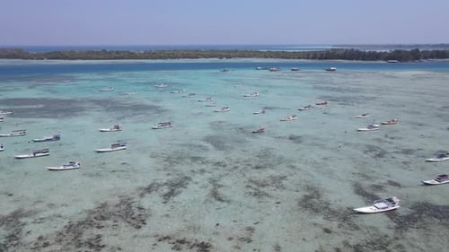 Top view or aerial view of beautiful clear water and white beach with fisherman's boats on summer tr