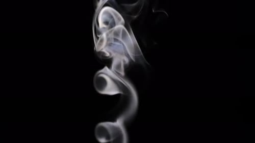 Abstract Wispy Smoke Flowing on Black Background