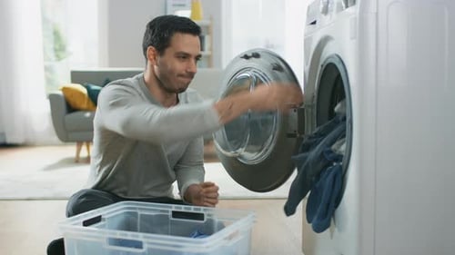 Man Doing Laundry in a Bright, Modern Home