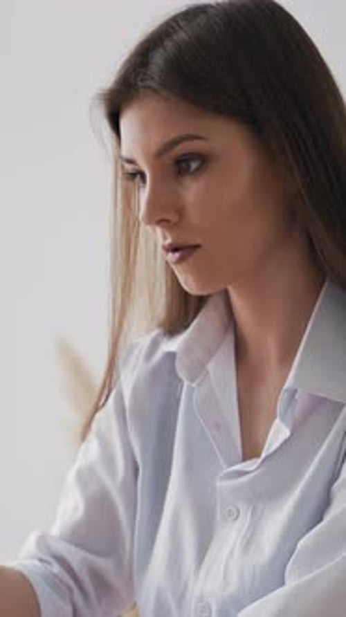 Woman in Shirt Draws Painting on White Canvas in Art Studio