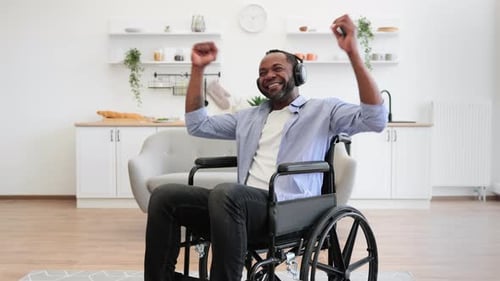 Man in Wheelchair Dances Listening to Music