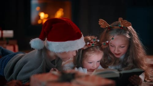 Children Reading Together by the Fireplace at Christmas