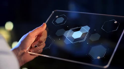 La main tient une tablette transparente affichant des chiffres et comptant sur la technologie de l'écran