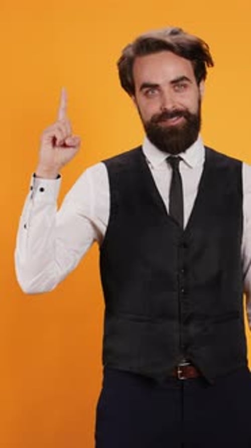Vertical Video Elegant Butler Points Up on Camera