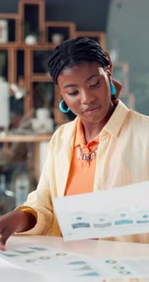 Documents, information and reading with business black woman at desk in office for review of charts