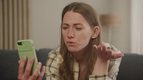 Woman Talking on Phone at Home on Couch