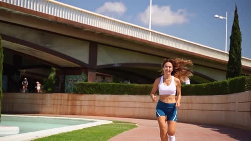 Woman Jogging in Urban Park During the Day