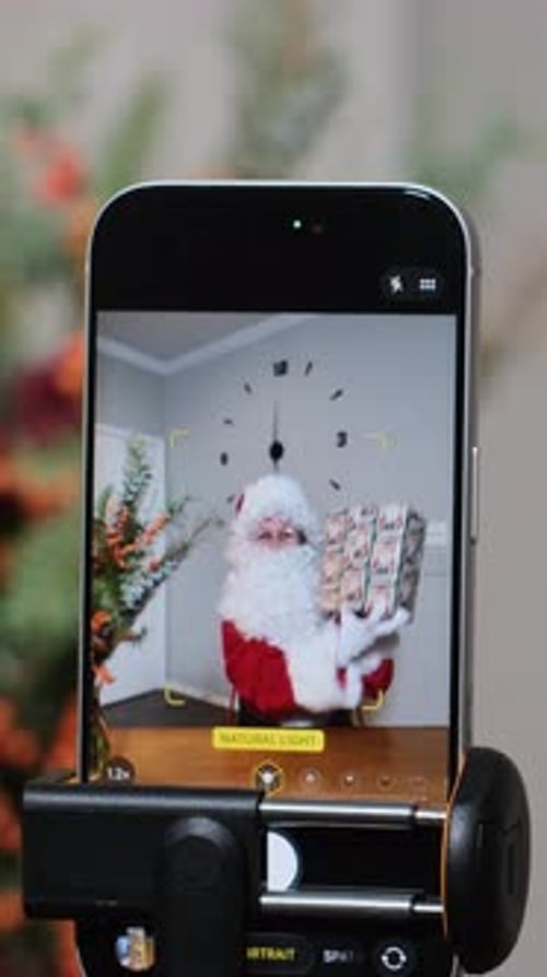 Smartphone Recording Santa Claus Holding Christmas Gifts