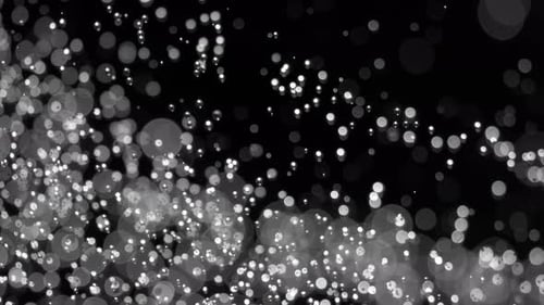 Abstract Shimmering White Bokeh Particles on Black