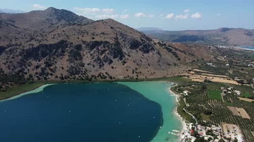 Kournas freshwater turquoise lake in Crete, Kournas mountainous village, Drone shot