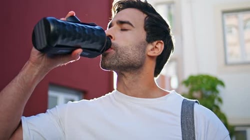 Man Drinking Water Bottle Outdoors at Sunlight Closeup Guy Sipping Beverage