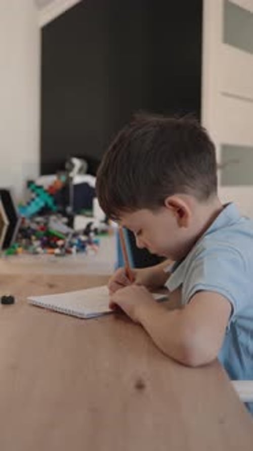 Young Boy Drawing in Notebook at Home Focused Child Creative Activity and Educational Development