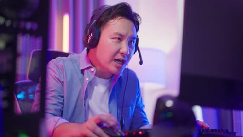 Young Adult Gamer Plays Video Game at Night