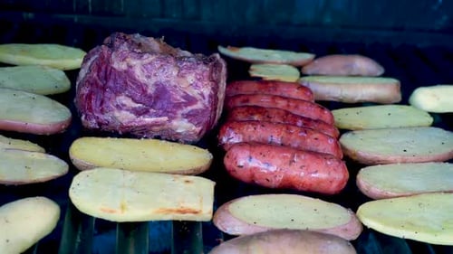 Meat and Potatoes Cooking on Barbecue Grill