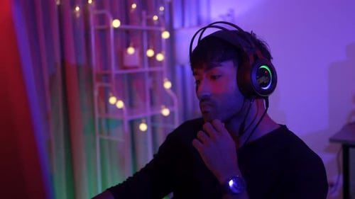 Young Adult Gamer Focused in Colorful Room