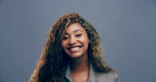 Smiling Young Woman Gives Thumbs Up to Camera