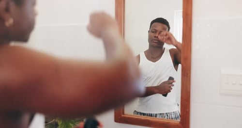 Man Applying Deodorant in Bathroom Mirror