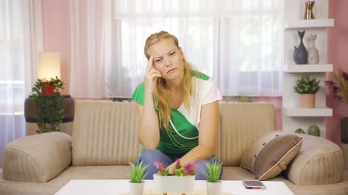 Woman Thinking While Sitting on a Couch