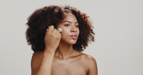 Studio, woman and brush for makeup, beauty and foundation for skin with cosmetics