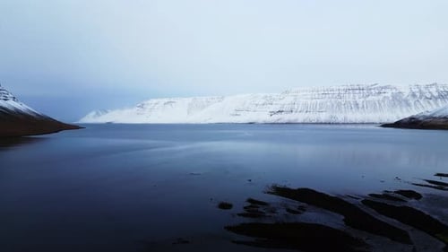 Vast Winter Landscape With Snowy Mountains And Lake