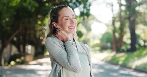 Woman Standing on Street Massaging Neck