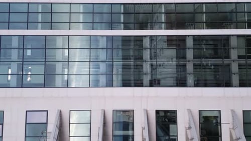 Aerial View of Moving Elevator Walls and Windows of Contemporary Business Center at Evening