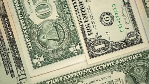 One American dollar banknotes lie on white surface rotating table close-up US national currency