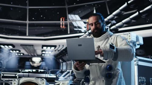 Astronaut Reviewing Onboard Analytics on Laptop Before Stepping Out of Station