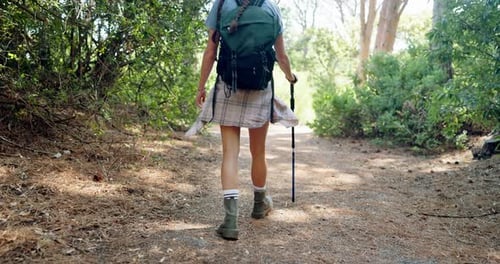 Woman Hiking on Trail in Green Forest