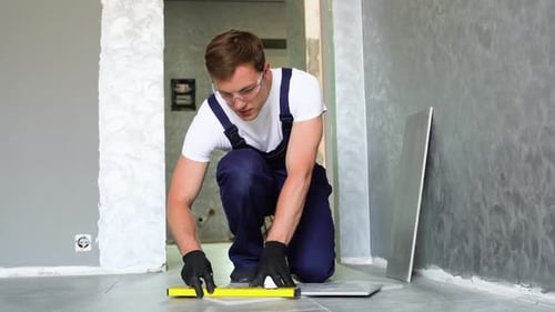 Young Adult Leveling Floor Tiles in Home