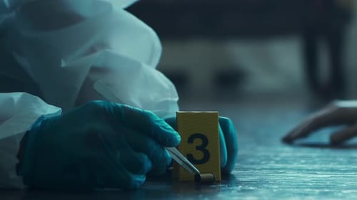 Forensics Expert Picking Up Bullet Casing at Crime Scene